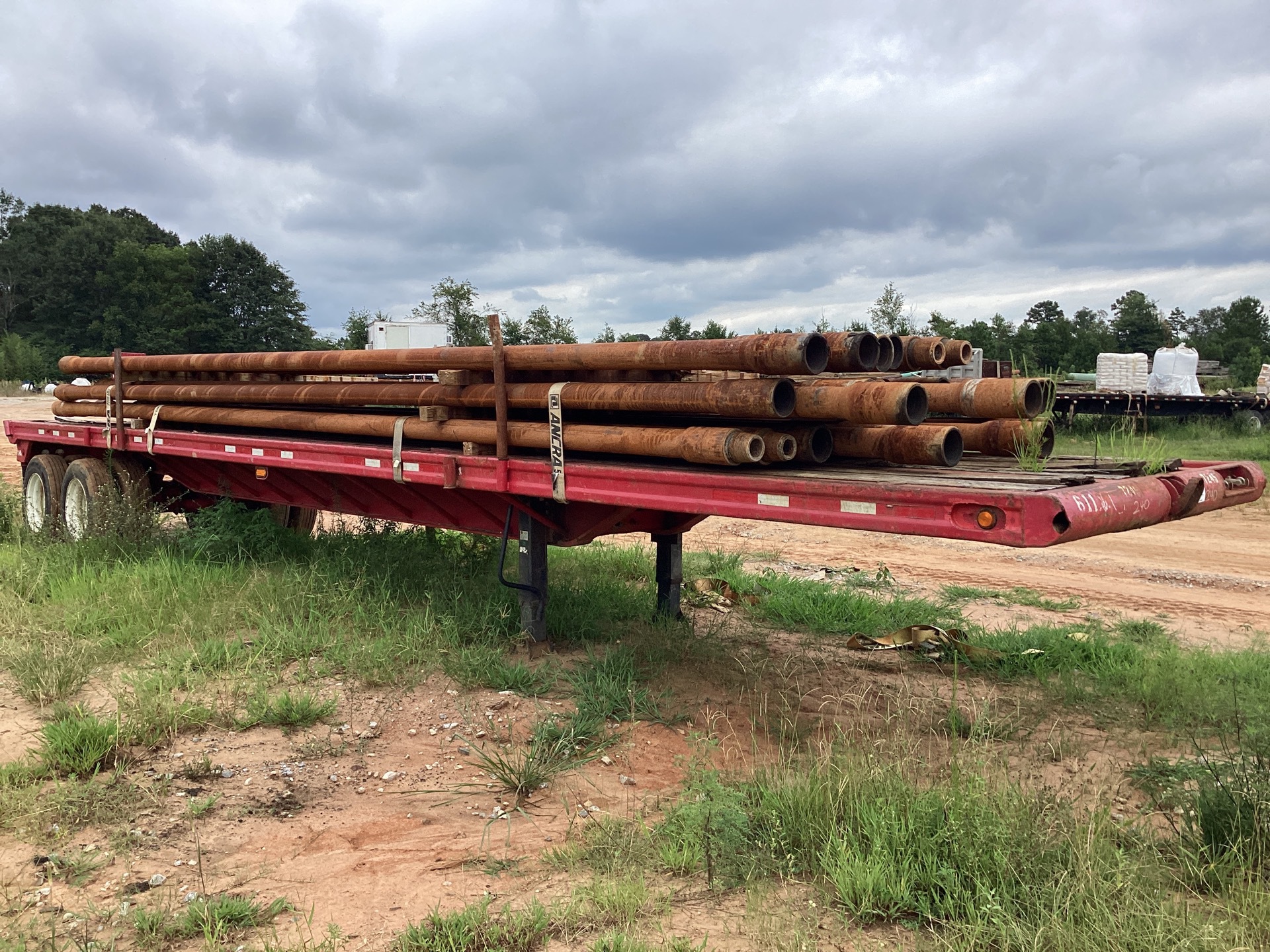 Quantity of (37) 5-1/2 in Range 2 Drill Pipe w/ 1979 Nabors Flatbed Trailer